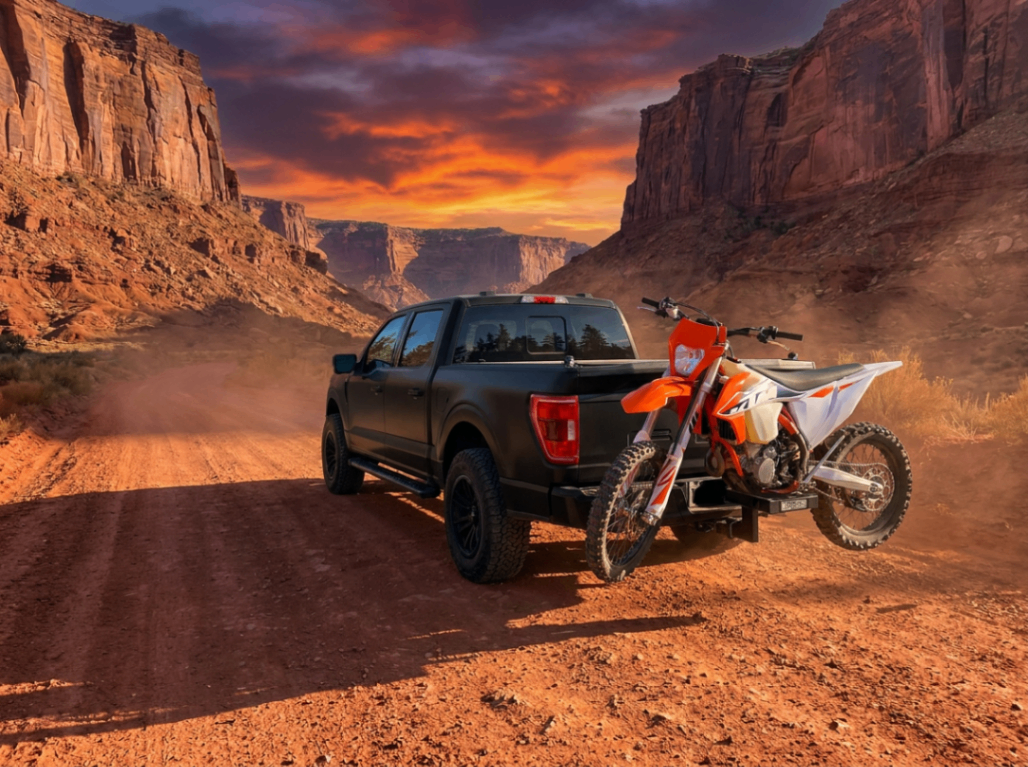 KTM dirt bike on eMotorack carrier at canyon sunset